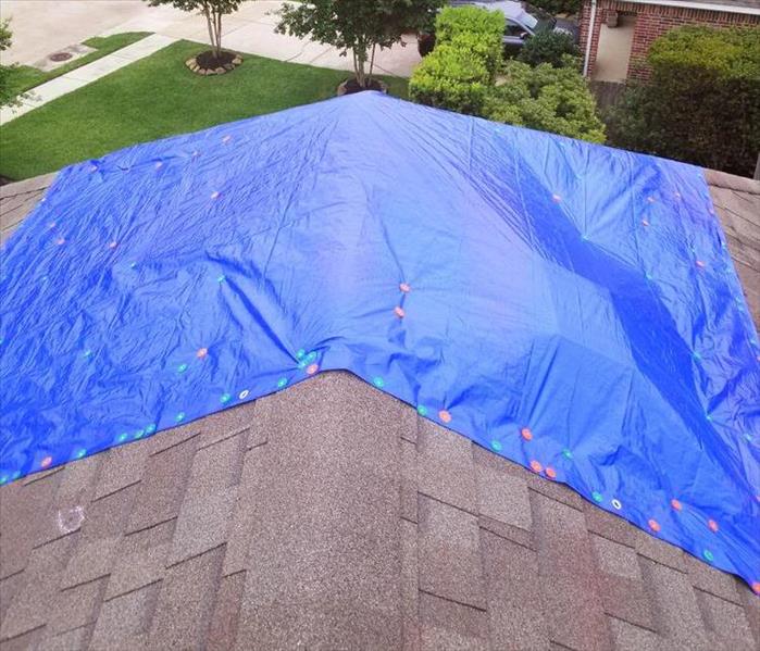 Blue tarp on a roof.